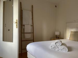 a bedroom with a bed with towels on it at LE ROI SOLEIL • 4min Château Versailles • 1min Gare Versailles Rive Gauche in Versailles