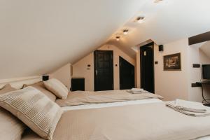 a bedroom with a large bed in a attic at Forest House in Palić