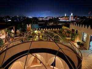 a balcony with a view of a city at night at La Claire Fontaine in Marrakesh