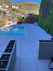a tile patio with a swimming pool in a house at DouroXisto in Peso da Régua