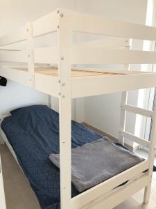 a white bunk bed in a room with a blue bed at Villa Peony Koroni in Koroni