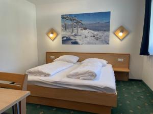 a bedroom with two beds and a picture on the wall at Apartment Heijerhof - Top 4 in Wagrain
