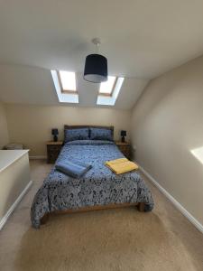 a bedroom with a bed in a room with a window at Cosy 3 bedroomed home on 3 floors in Darlington
