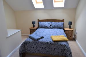a bedroom with a bed and two night stands at Cosy 3 bedroomed home on 3 floors in Darlington