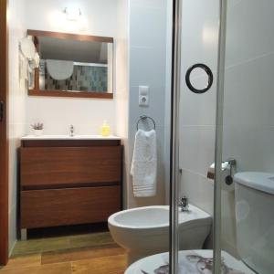 a bathroom with a toilet and a sink and a shower at las llaves del arca in Trujillo +15 photos