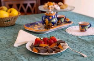 a table topped with plates of food with strawberries and desserts at A Casa ra Signurina in Modica +36 photos