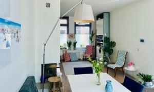 a living room with a white table and chairs at Family Beach House Zandvoort City Center in Zandvoort +7 photos