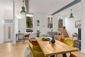 a dining room and living room with a table and chairs at Loft-Appartements mit Terrasse in Bremen