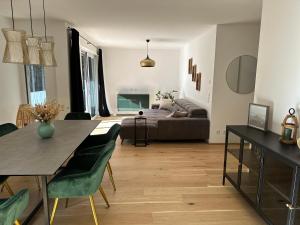 a living room with a table and a couch at Waldblick Wohnung in Traunreut