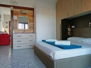 a bedroom with two beds and a dresser at Studio Apartment Residenza del Sole in La Maddalena