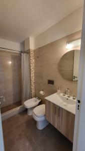 a bathroom with a toilet and a sink and a mirror at Mi corazon en San Telmo in Buenos Aires