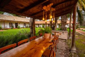 a wooden table and chairs on a patio at Hotel Boutique Raíces de Colchagua in Santa Cruz