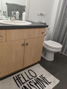 a bathroom with a sink and a toilet and a welcome mat at Central location close to Downtown and Mountain Views in South Salt Lake +29 photos