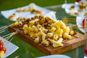 a wooden cutting board filled with cheese and nuts at Hotel Boutique Raíces de Colchagua in Santa Cruz