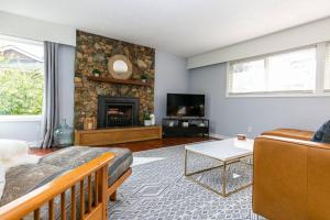 a living room with a couch and a fireplace at Sunrise Escape - Close to the BEACH! in Victoria