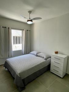 - une chambre avec un lit et un ventilateur de plafond dans l'établissement Apartamento Vista Mar - Marina, à Praia Grande