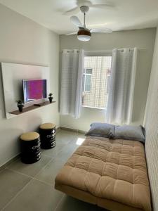 - une chambre avec un lit et deux tabourets dans l'établissement Apartamento Vista Mar - Marina, à Praia Grande