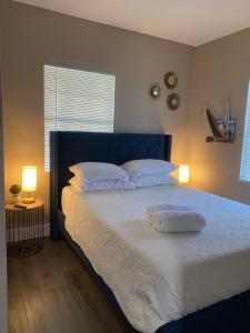 a bedroom with a large bed with two pillows on it at Bella Breeze in Sanford