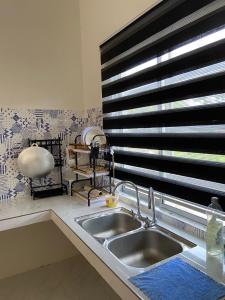 a kitchen with a sink and a window at Inap desa homestay batu buruk in Kuala Terengganu