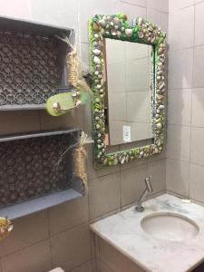 a bathroom with a sink and a mirror at Casabella in Lucena