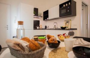 a kitchen with a basket of food on a counter at Glamour Liberty Apartment Sabotino38 in Milan