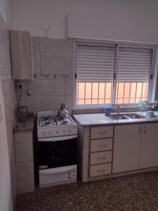 a small kitchen with a stove and a sink at Casa en Santa Rosa in Santa Rosa