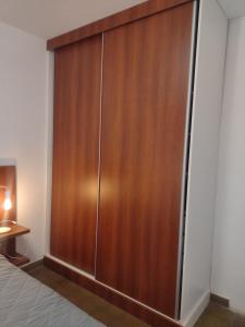 a wooden closet in a bedroom with a bed at Casa en Santa Rosa in Santa Rosa