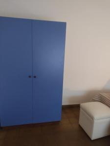 a blue cabinet in a room next to a couch at Casa en Santa Rosa in Santa Rosa