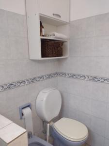 a bathroom with a white toilet and a basket at Casa en Santa Rosa in Santa Rosa