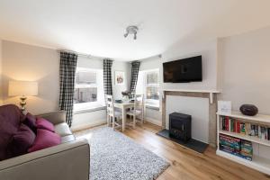 a living room with a couch and a fireplace at Vine Cottage in Hexham