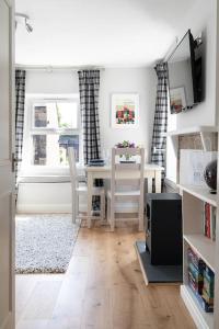 a living room with a table and a dining room at Vine Cottage in Hexham