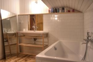 a bathroom with a sink and a bath tub at La Ribambelle in Chamonix