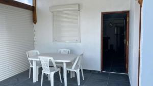 a white table and white chairs on a patio at Domaine de Dugay in Beauregard