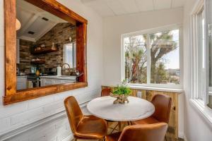 a dining room with a table and chairs and a mirror at JT Cottage in Yucca Valley