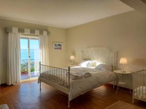 a bedroom with a bed with a view of the ocean at The Beachfront Casa da Rampa II in Sintra