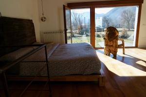 a bedroom with a bed and a large window at El Parreiro VUT-LE-610 Dúplex in Villablino