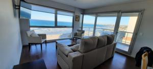 a living room with a couch and a table at Ventana al Golfo in Puerto Madryn