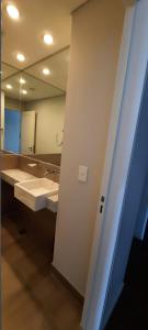 a bathroom with two sinks and a large mirror at Ventana al Golfo in Puerto Madryn