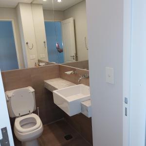a bathroom with a toilet and a sink and a mirror at Ventana al Golfo in Puerto Madryn +33 photos