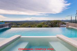 a swimming pool with a view of the mountains at Beach House 7 26 One Mile Close air conditioned wifi foxtel linen in Anna Bay