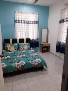 Schlafzimmer mit einem Bett, einem Spiegel und Vorhängen in der Unterkunft Jerai Geopark Cottage 2bedrooms in Yan