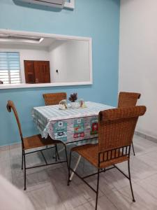 a dining room with a table and two chairs at Jerai Geopark Cottage 2bedrooms Pulau Bidan in Yan