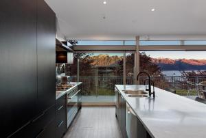 a kitchen with a large window with a view of the mountains at Remarkable Escape in Queenstown