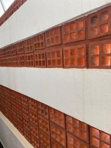 a brick wall with red squares on it at Casa Nostrum Priceless View Central Location 3BR 3BA in Punta del Este
