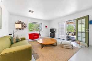 a living room with a couch and a table at Desert Dusk in Joshua Tree