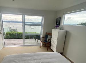 a bedroom with a bed and a large window at Wharf View in Russell