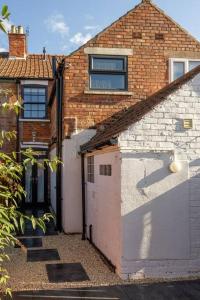 a brick house with a door and a garage at No6 - Beverley - Elegant Townhouse - Central location in Beverley