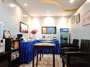 a room with a table with blue table cloth at Amax Inn Cebu in Cebu City