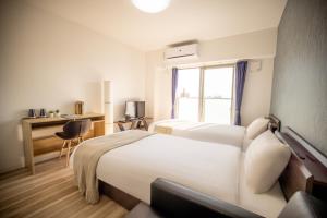 Letto o letti in una camera di RTi Tennoji