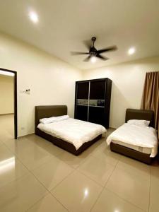 een slaapkamer met 2 bedden en een plafondventilator bij Villa 16pax 3BR with Spa Pool n Pool Table near SPICE ARENA in Bayan Lepas